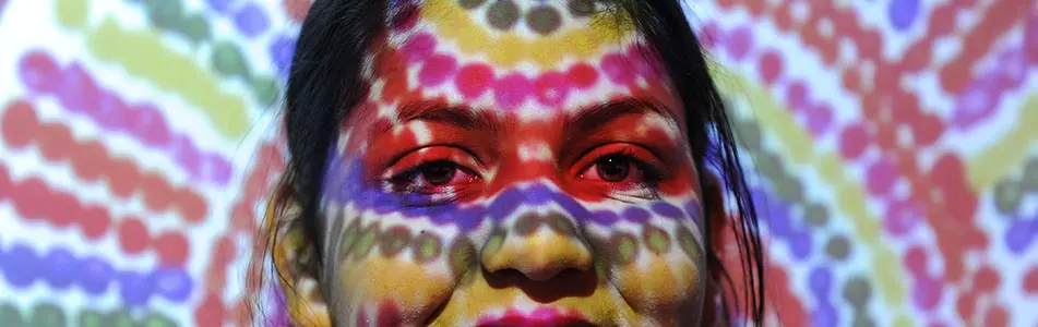 Female with multi-colour digital art on face